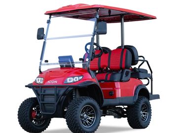 Red off-road golf cart with rugged tires and roof.