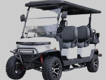 White and black golf cart with rugged tires and cushioned seats.