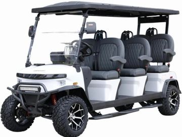 A white six-seater golf cart with black roof and rugged tires.