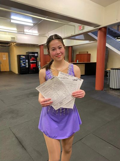 A skater posing with her test forms. 