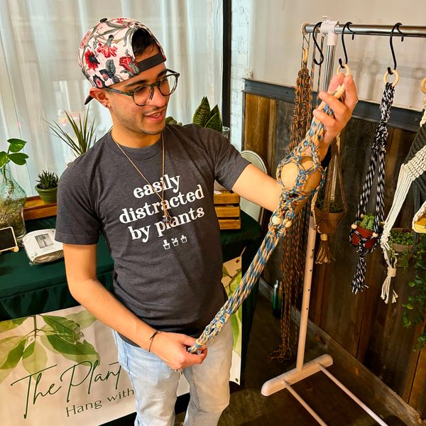 brian at the plant outfitter admiring his plant hangers