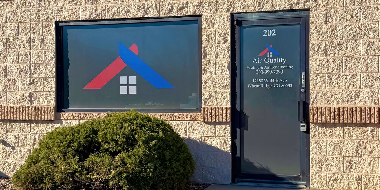 Exterior of Air Quality Heating & Air Conditioning office with blue sky.