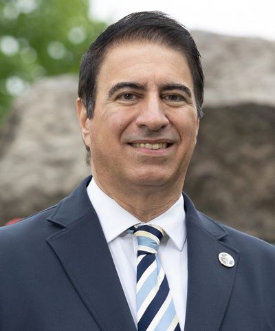 Man in suit smiling outdoors