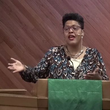 A person speaking passionately at a podium.
