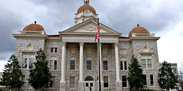 Historic courthouse building with dome and columns.