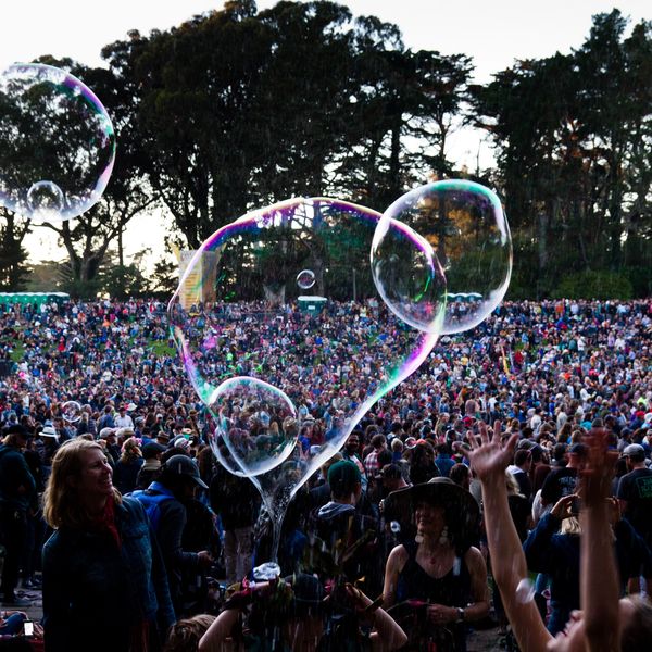 a large crowd of people with bubbles