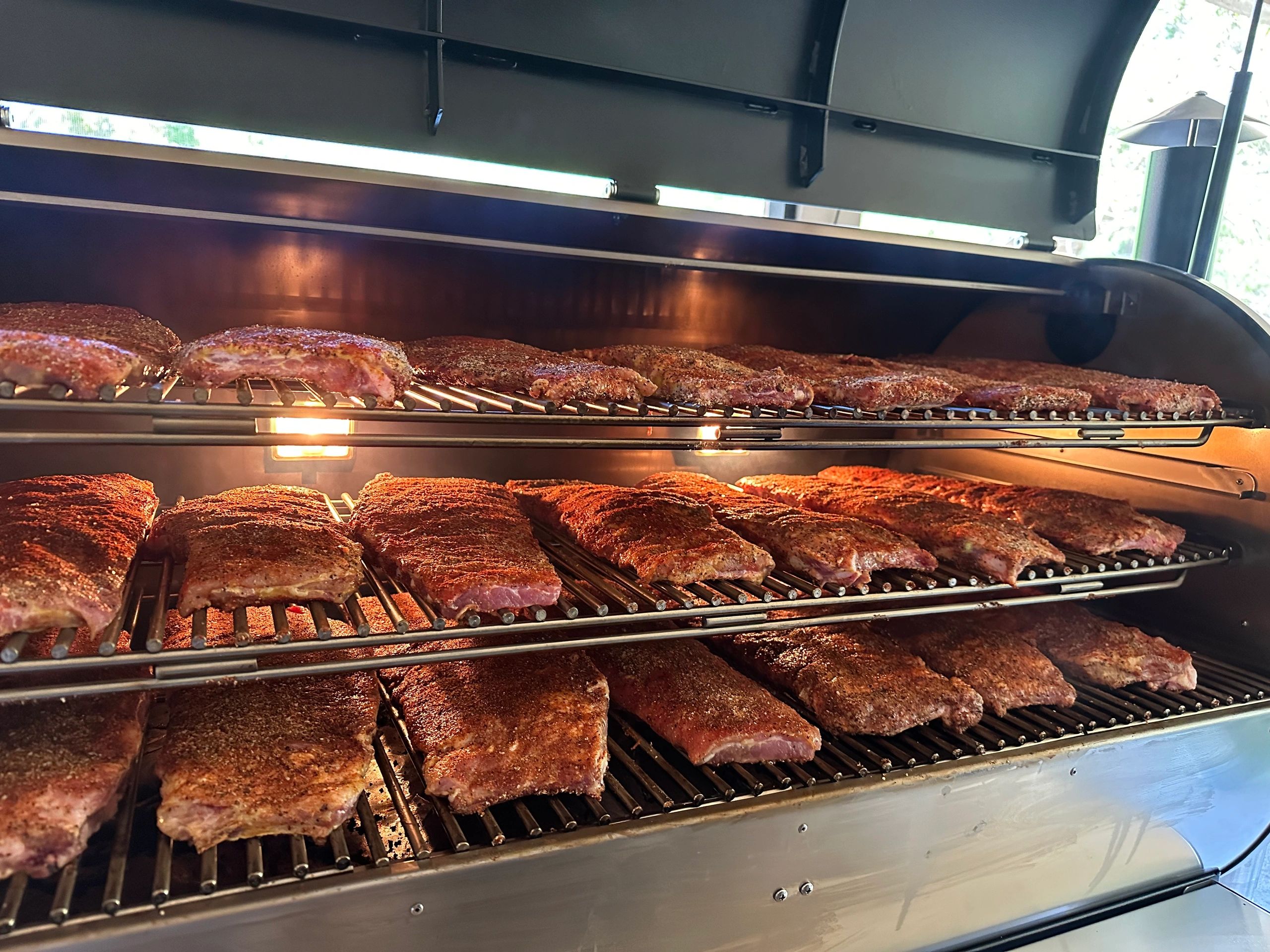 Smoking ribs to Perfection for our dry rub and Signature Ribs from Runyon’s Smokehouse!