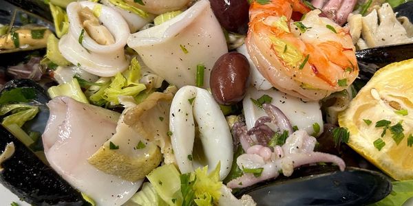 seafood salad, shrimp, clams, calamari. mussels, lemon