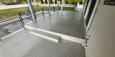 Raised concrete patio step with light fixture.