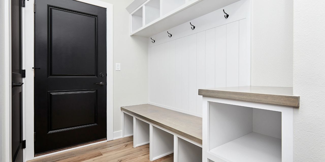 Functional mudroom with built-in storage, coat hooks, and seating creating an organized everyday entrance to the home.
