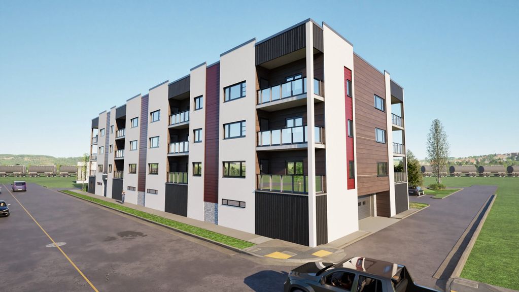 Modern four-story apartment building with balconies and mixed exterior materials.