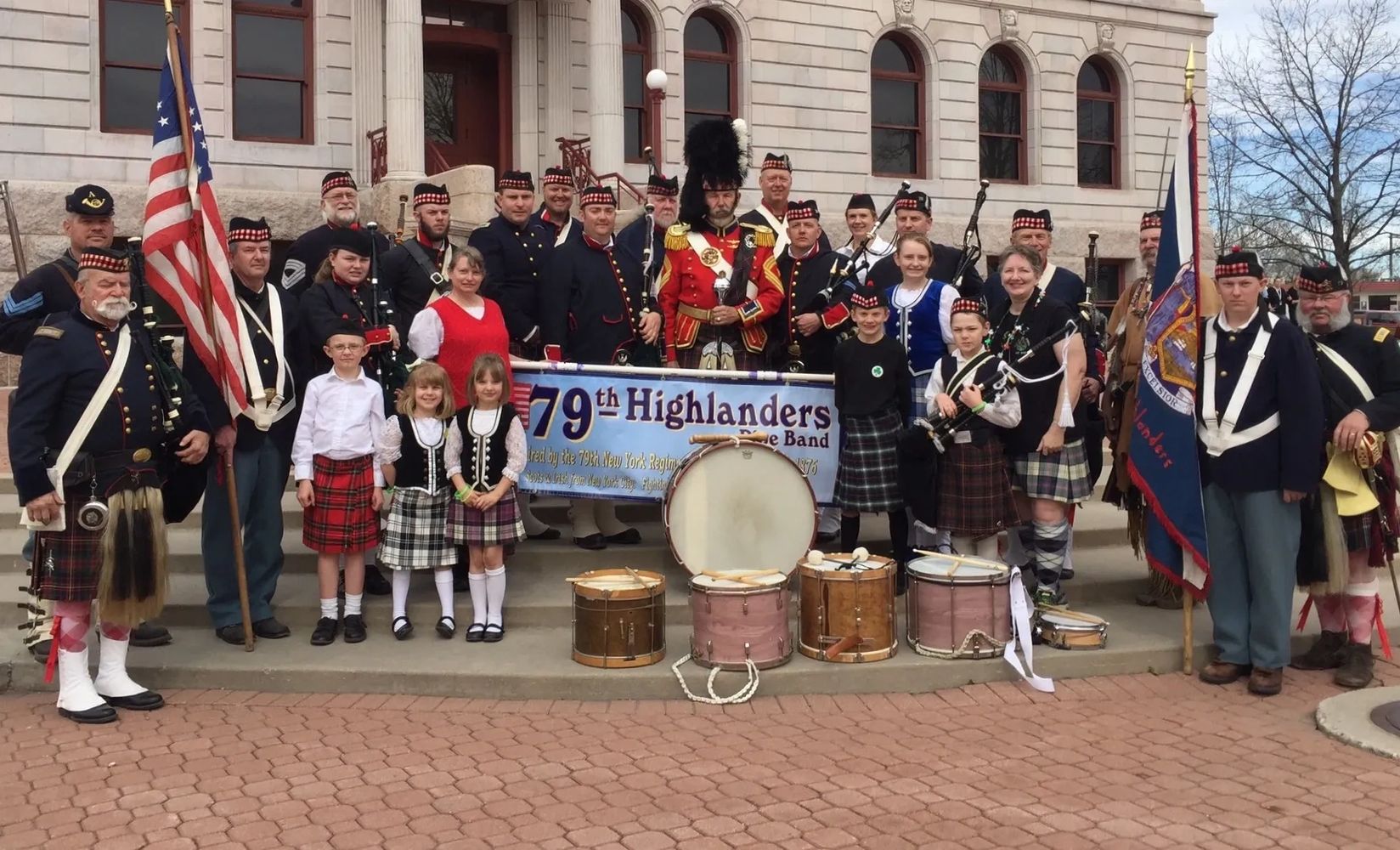 Group photo of the 79th NY Vol Inf "Highlanders" Pipes and Drum Band in from of the Colorado Springs