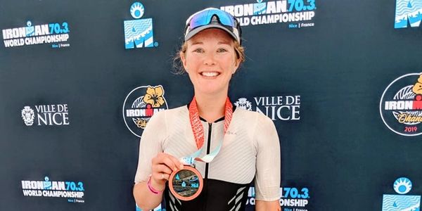 A woman holding her medal