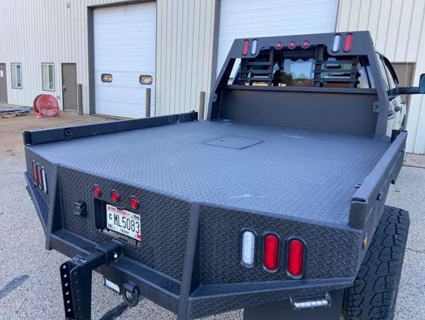 Spray-in bedliner with coated external accessories on a flatbed truck serviced in Madison, Wisconsin