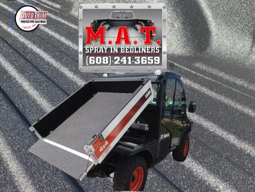 Bobcat utility vehicle with spray-in bedliner and contact info for M.A.T. Spray In Bedliners.