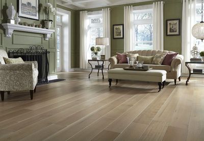 Elegant living room with light wood flooring and classic furniture.