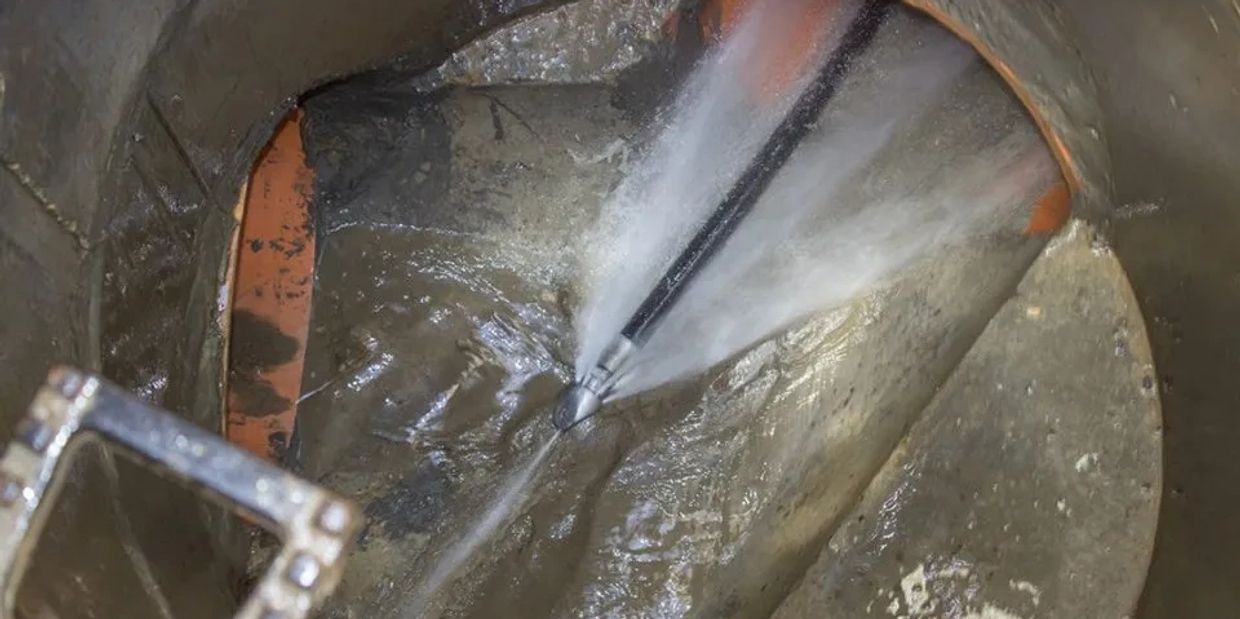 A high pressure jetter being used to clear a drain