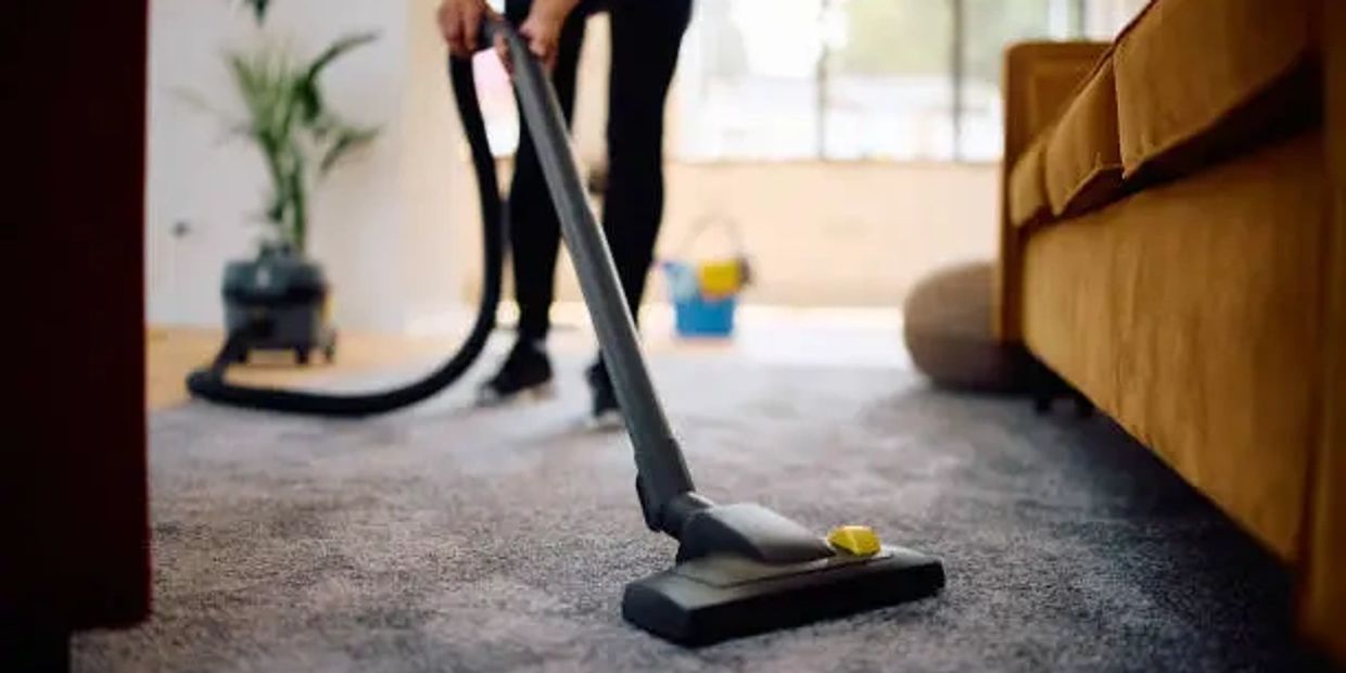 Man using HEPA vacuum on carpet