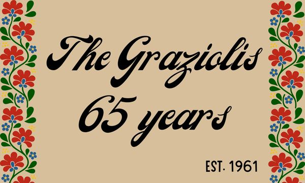 A family name sign celebrating 65 years since 1961 with floral borders.