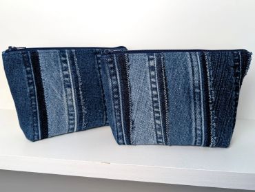 Two denim zippered pouches with striped patterns.