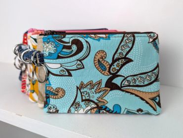 Floral patterned fabric pouch with key rings.