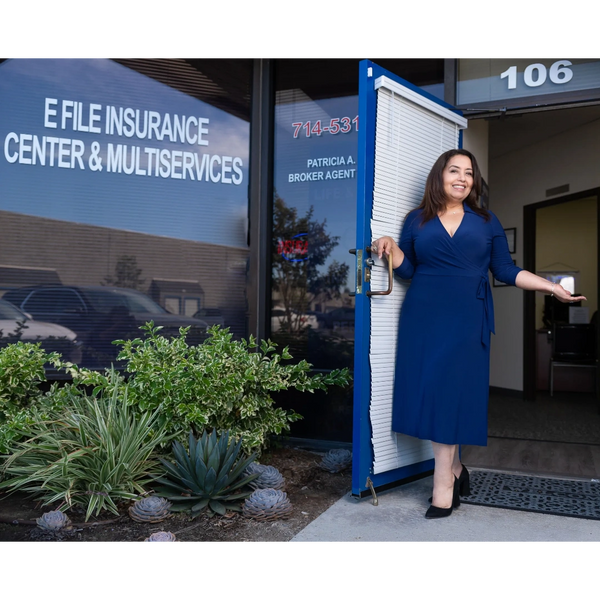 Woman in blue dress standing at door 