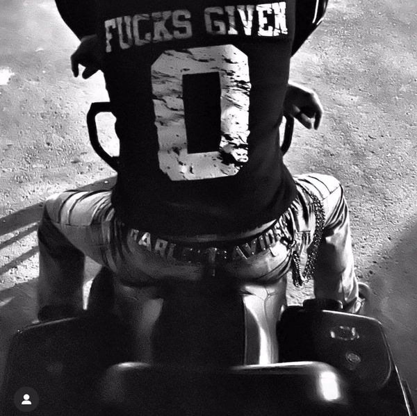 A man sitting on a classic cruiser bike