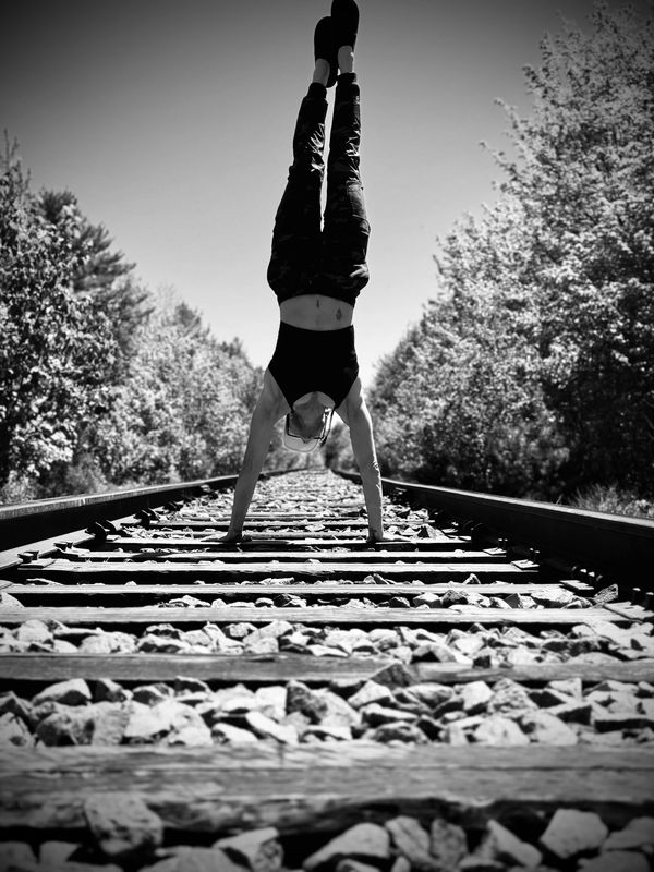 A woman doing exercise on train track