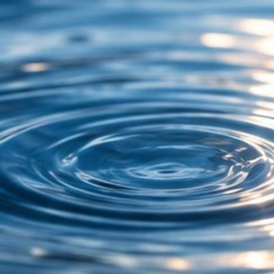Ripples in a calm blue water surface.