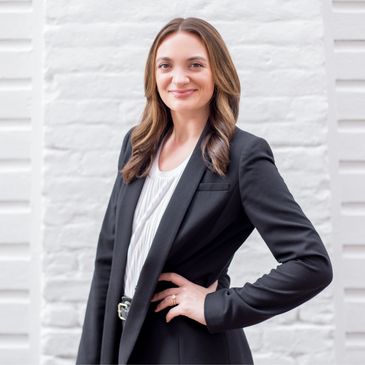 Kelly Snyder standing in front of brick wall on unity alley 