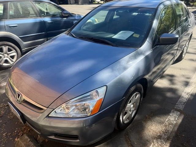 A gray Honda sedan parked on a sunny street.