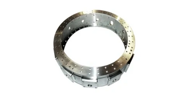 A metallic circular component with holes, possibly an industrial part.