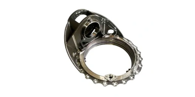Shiny metallic mechanical component with circular opening and gear-like edges.
