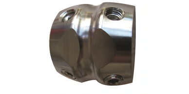 Close-up of a shiny metal connector with threaded holes.