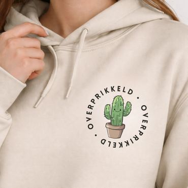 Beige hoodie with a cute potted cactus and 'OVERPRIKKELD' text design.