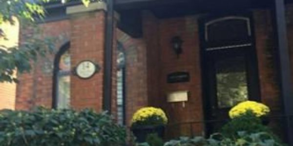 Entrance of a brick house with plants.