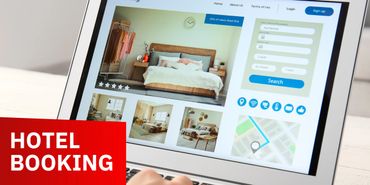 Person booking a hotel room online on a tablet.
