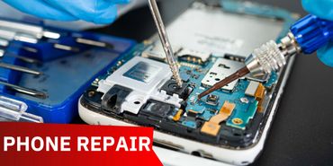 Close-up of smartphone circuit board being repaired with tools.