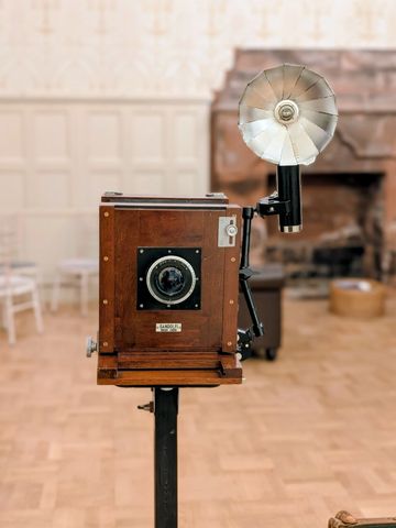 The Photobooth Co Scotland’s vintage wooden camera photo booth set up at an elegant wedding venue