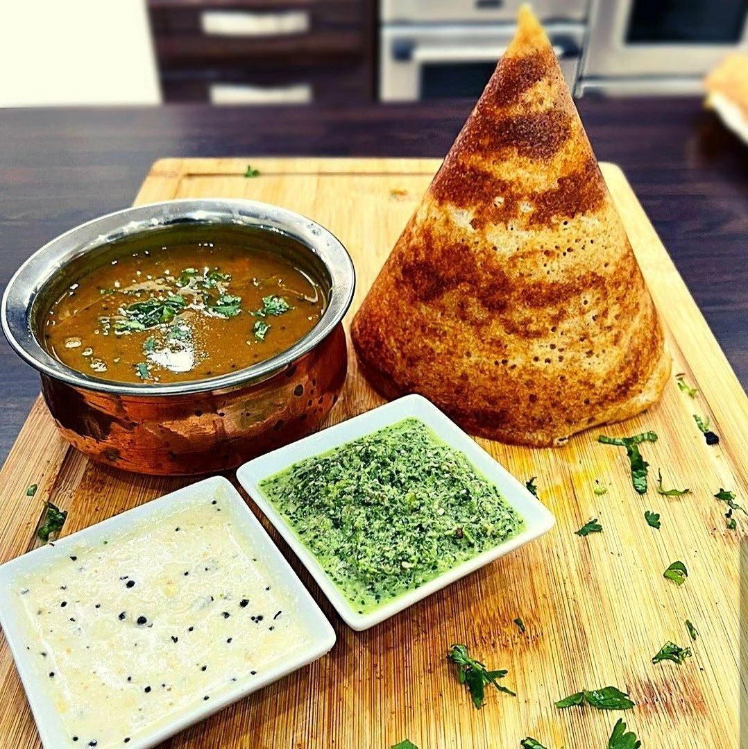 vegetarian dosa on wood plate with sauce