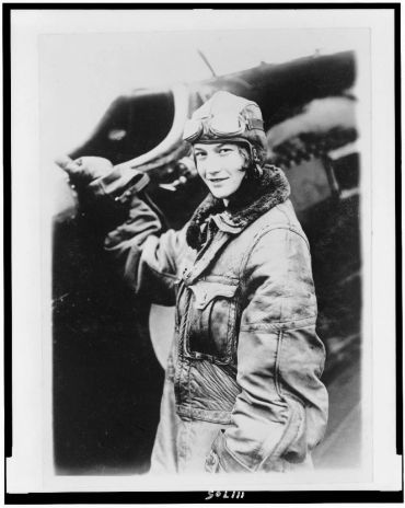 Historic photo of a female pilot in leather flight jacket and goggles.
