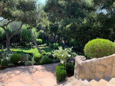 Exterior stone staircase into a lush and professionally landscaped yard.