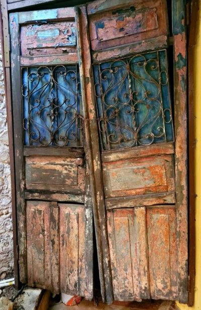 Old weathered wooden door with peeling paint.