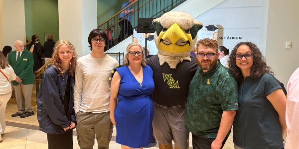 Group photo with a mascot indoors.