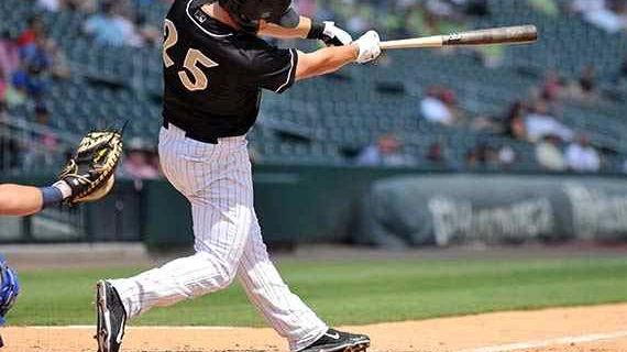 Chris Curley swinging in a minor league baseball game