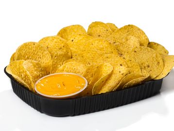 Tray of tortilla chips with cheese dip.