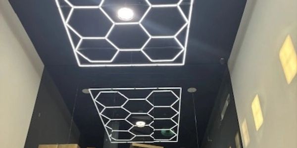Ceiling with hexagonal light fixtures in a modern interior.