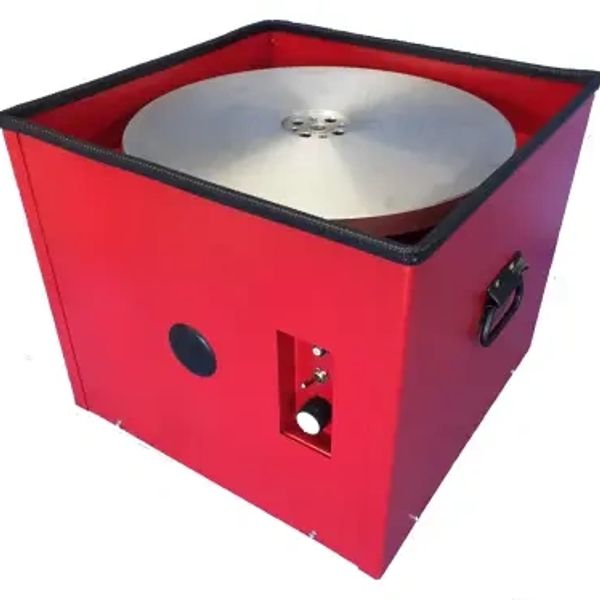 Red pottery wheel machine with metal wheel and control knob.