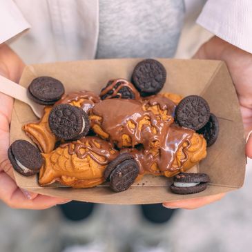 Taiyakitos bañados en topping de nocilla y con mini galletas oreo en nuestras heladerías LA PECERA.