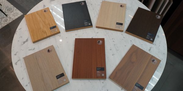 Wood veneer samples on a round marble table.